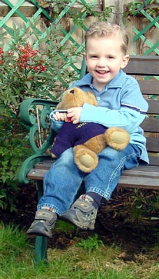 Joshua enjoying his teddy in the sun