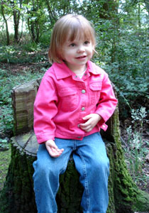 Misha in a tree stump chair in a wood near our house