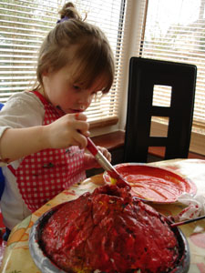 Misha carefully paiting her volcano model