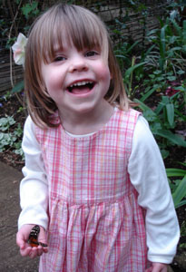 Misha delighted that a butterfly landed on her hand