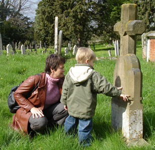 Joshua & Merryl look at the inscriptions on some gravestones in Bruaghing (pronounced "Bruffing")