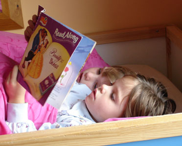 Precious moments together... Joshua & Misha read a story together in Misha's bed