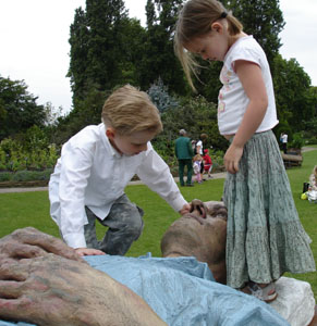 Joshua & Misha admire a large statue in Regents Park, London