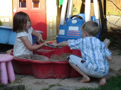 The children establish a sand-coin foundry in the garden