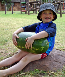 Joshua holding the watermelon before we cut it up