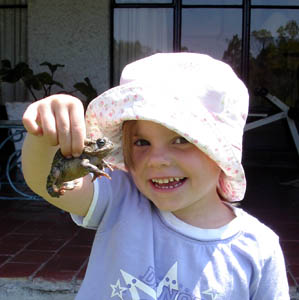 Misha proudly displays a bullfrog she caught
