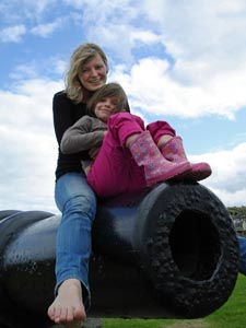 Kirstie and Misha sit on a cannon at Wicklow town