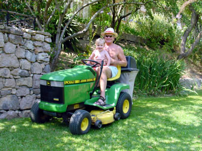 Joshua takes a ride on Grandpere's lawn mower at La Gorra