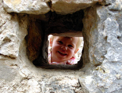 Misha pearing through a fortress window at St. Agnes