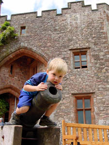 Joshua straddles a cannon at Muncaster Castle