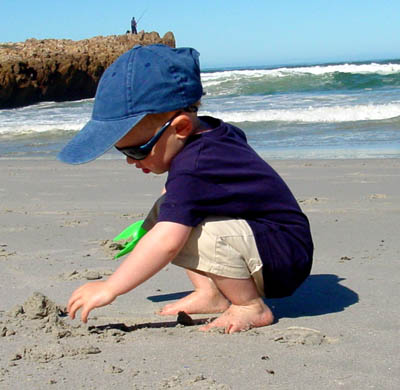 Joshua digging in the sand in Hermanus