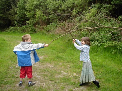 Sword fighting in a forest clearing